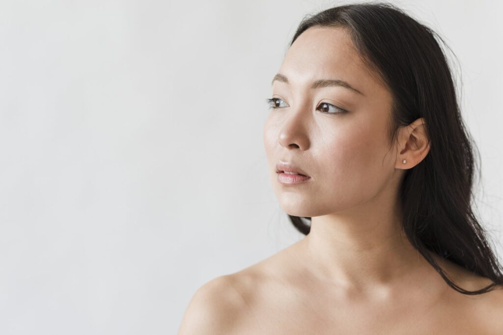 Woman-showing smooth-looking-neck-during-a-neck skincare-treatment in-Singapore